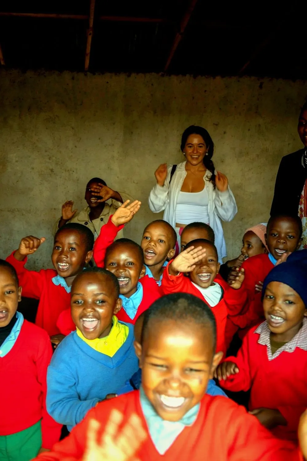 Schoolchildren cheering and waving in a classroom at the Nanyaro Foundation school in Manyara, Tanzania