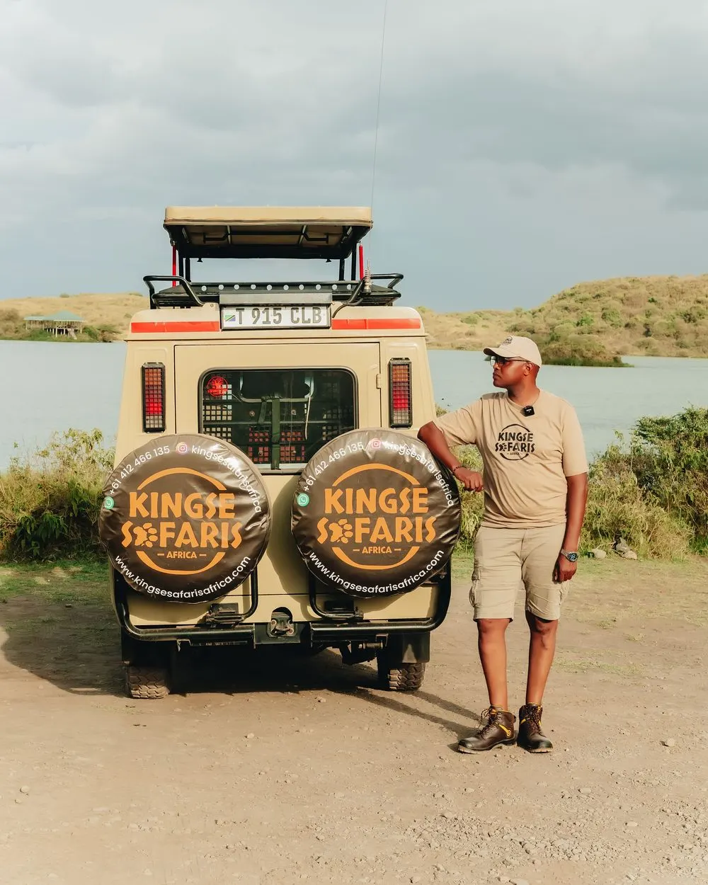 Peter Nanyaro, senior guide, beside the Kingse Safaris vehicle