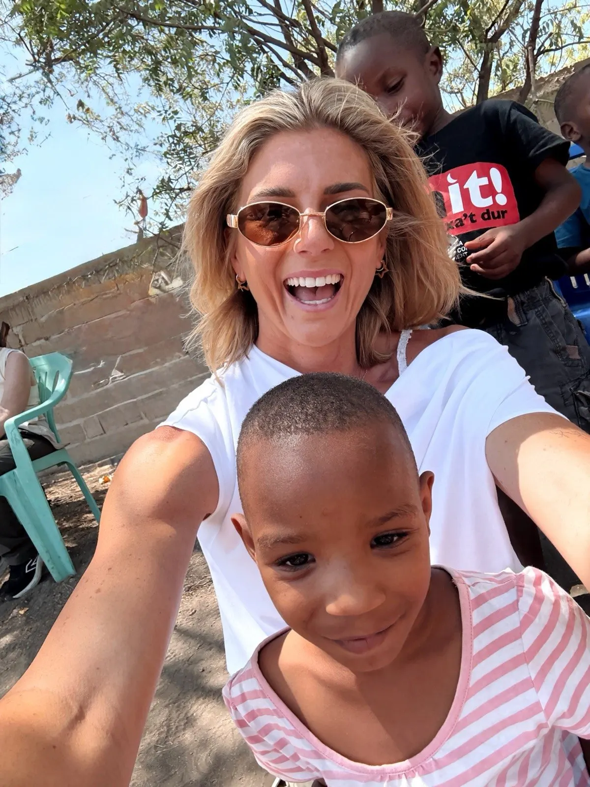 A Kingse Safaris guest meeting a child during a visit to the Manyara community school